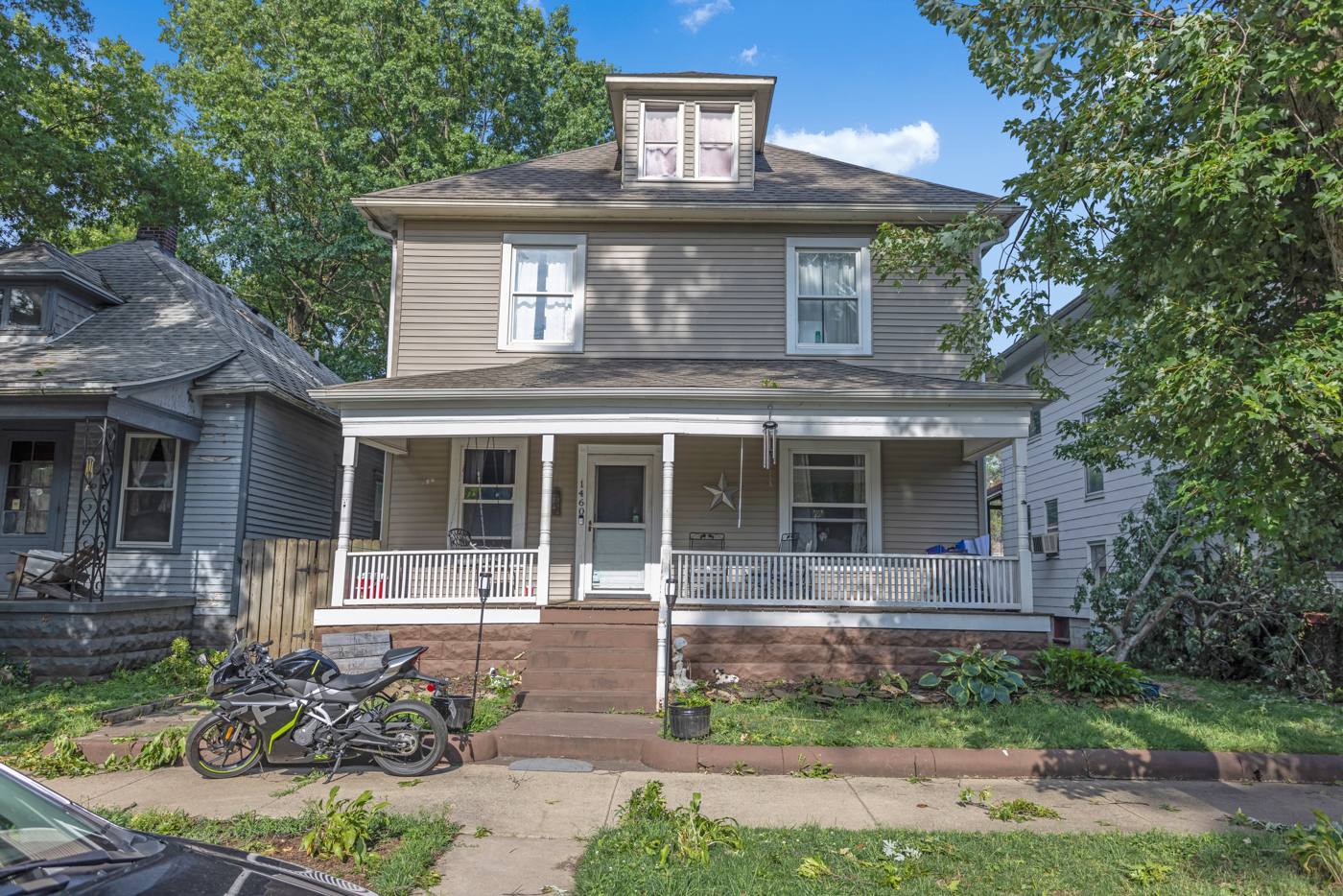 Classic American Foursquare home with front porch purchased as-is