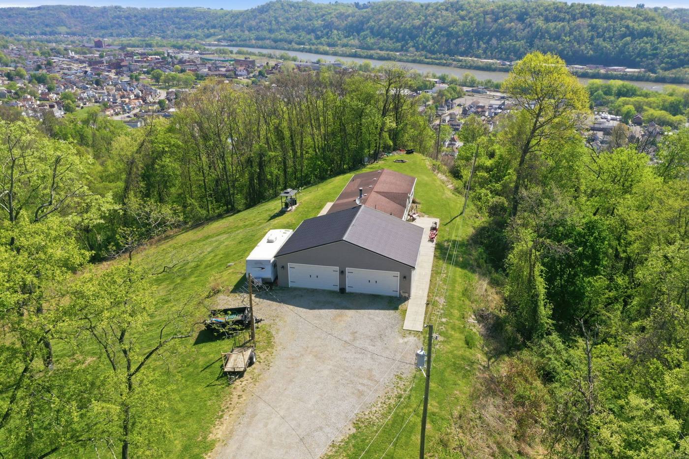 Aerial drone photo of a hilltop property purchased as-is